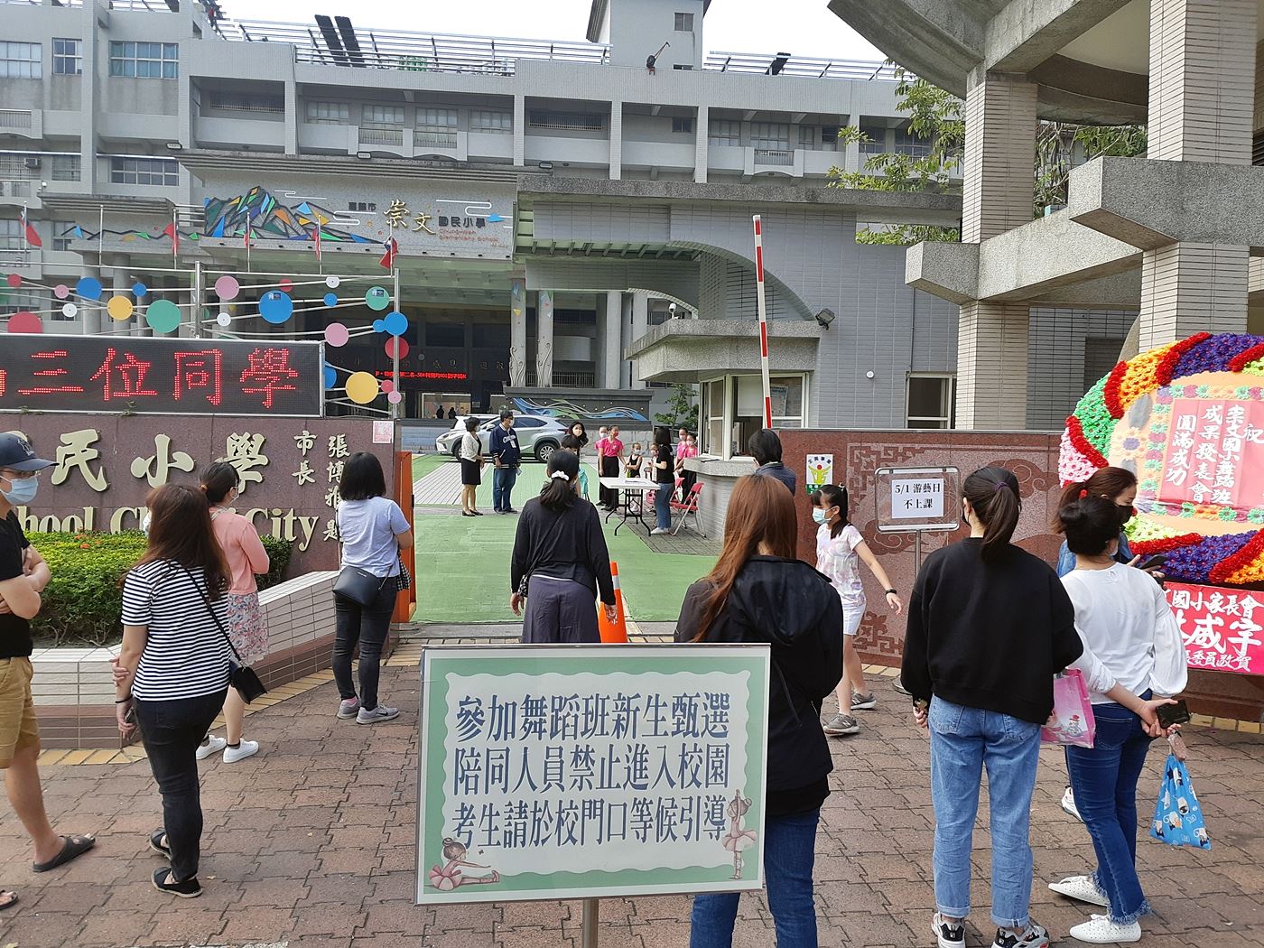 家長於門口送小朋友進場比賽